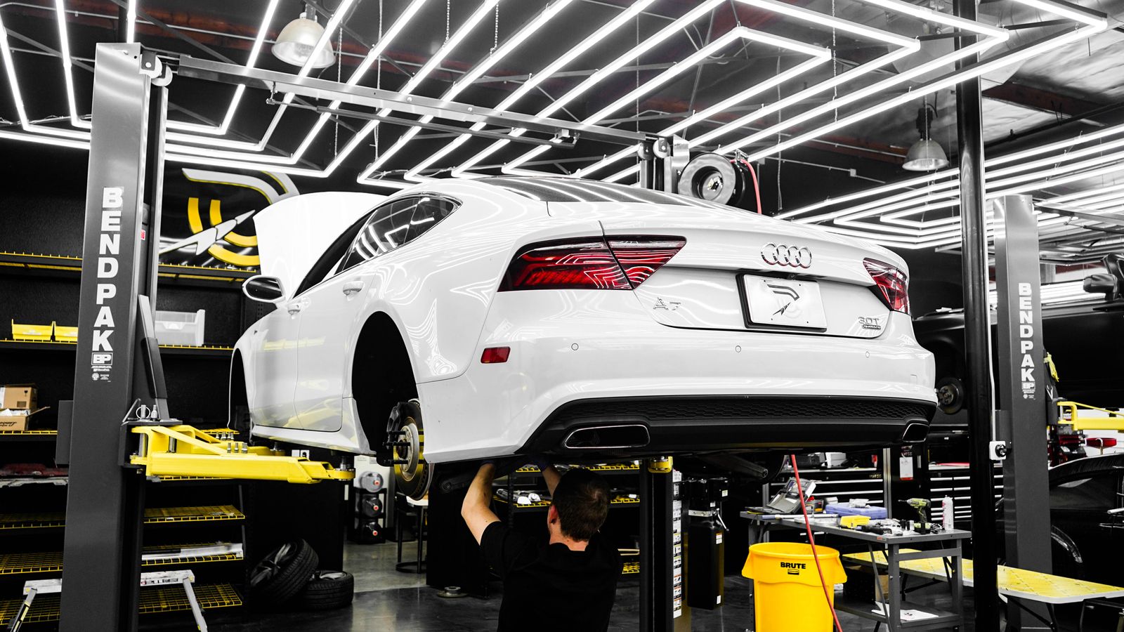 Vehicle on a lift inside an autobody repair garage