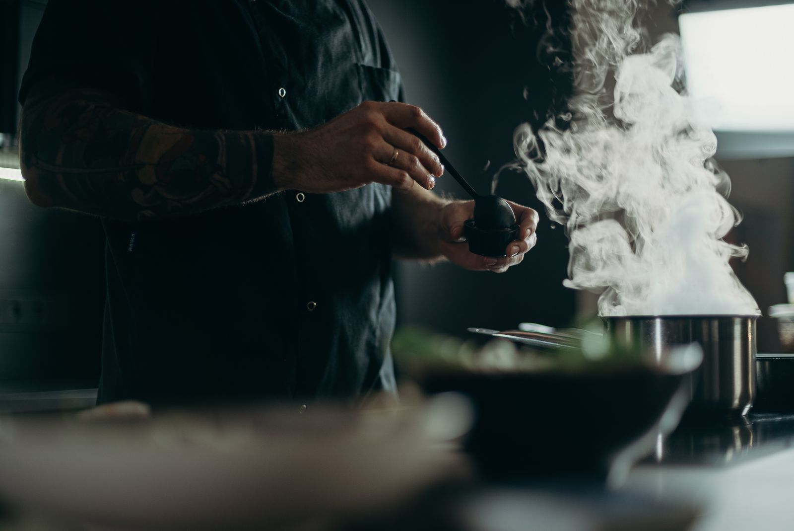 Chef in white uniform preparing food in a restaurant kitchen