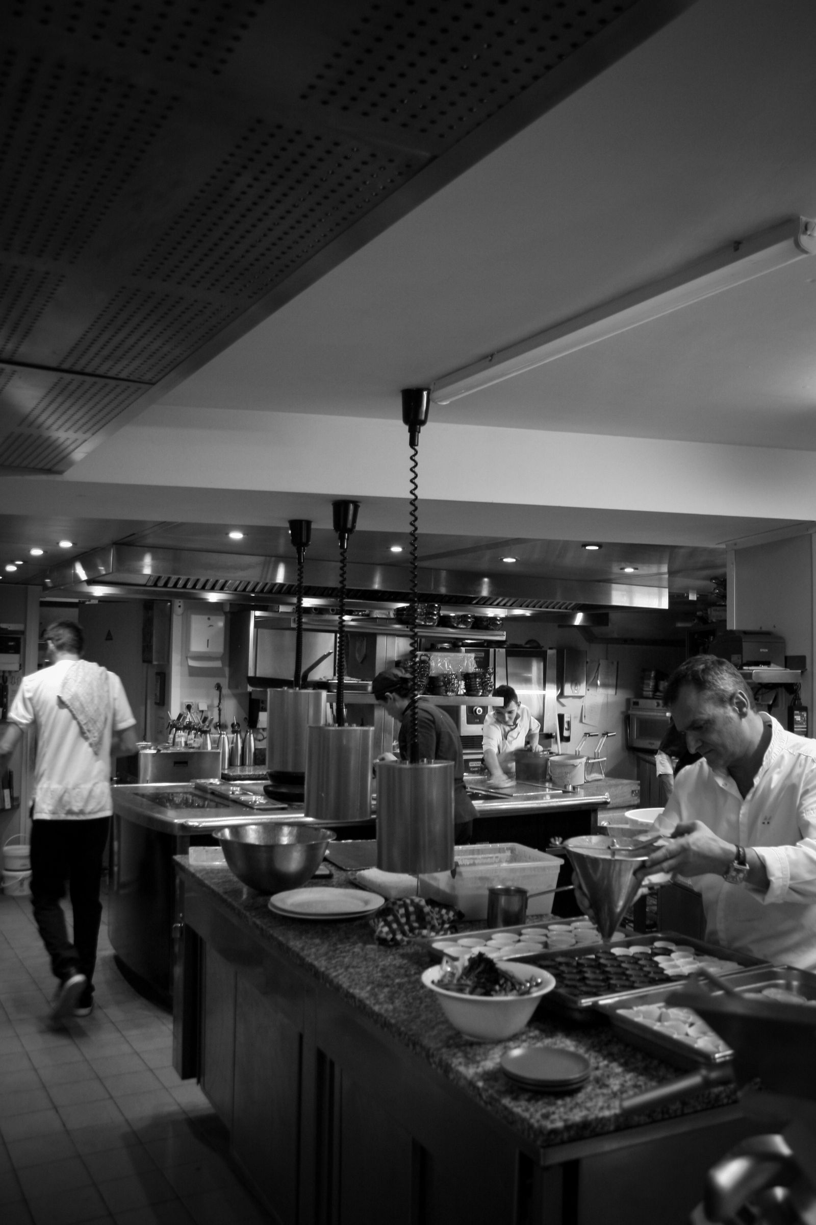 Chefs and kitchen staff working in a professional commercial kitchen