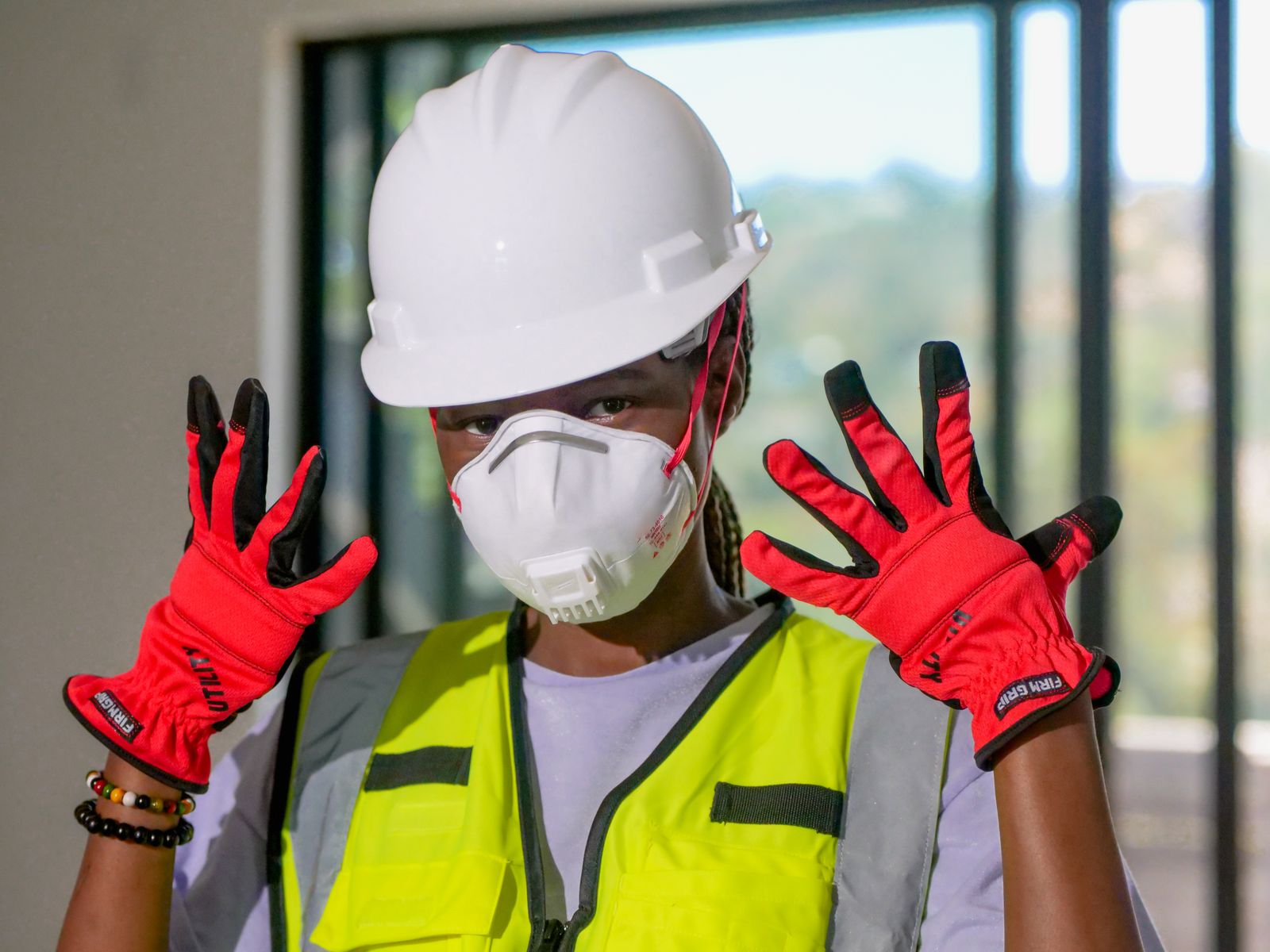 Worker wearing protective workwear and safety equipment on an industrial site