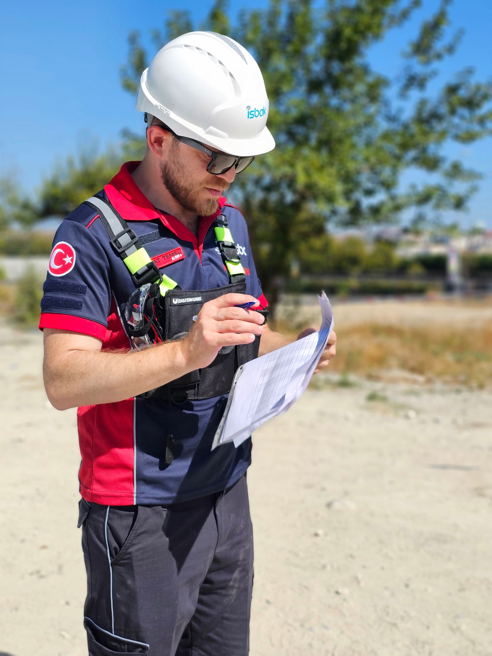 Professional in workwear reviewing documents on site
